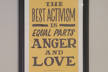 A framed poster that says "The best activism is equal parts anger and love. Ladyfingers Press 2018"